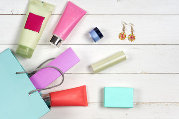 Woman's cosmetics and accessories on wooden background. Beautiful make up bag with cosmetics