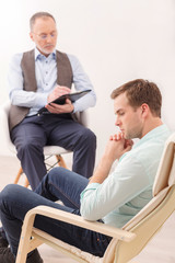 Handsome guy sharing problems with psychotherapist