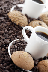 cup of coffee with beans and cookies.