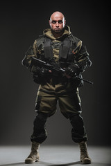 soldier man hold Machine gun on a  dark background