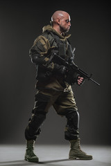 soldier man hold Machine gun on a  dark background