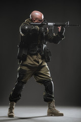 soldier man hold Machine gun on a  dark background