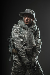 Special forces soldier man with gun on a  dark background