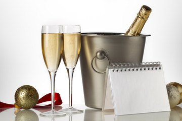 champagne bottle, flutes and ice bucket with christmas baubles