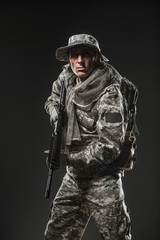Special forces soldier man with Machine gun on a  dark background