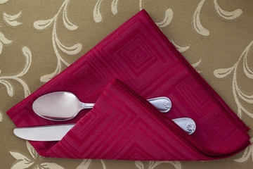 folded red cloth and utensils