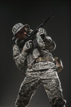 Special forces soldier man with Machine gun on a  dark background