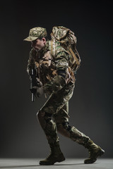 Soldier man hold Machine gun on a  dark background
