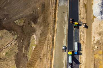 Road rollers working on the construction site aerial view