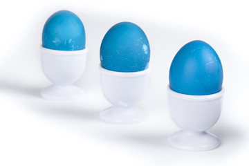 blue easter eggs in white cup