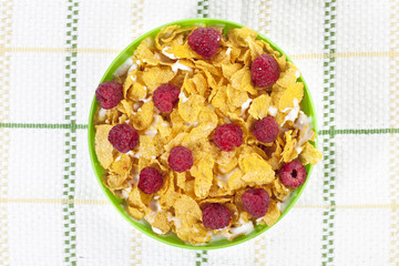 cereal and raspberries with milk in a bowl