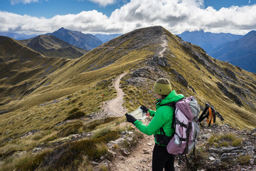 Woman hiker looing at the map of Kepler Track - 109969939