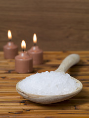 Fototapeta na wymiar salt on a wooden spoon and candles