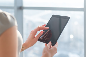 Woman using pda applications with wi-fi internet, touching screen, browsing information, close-up picture. 