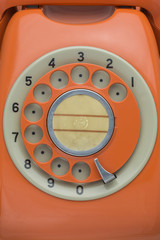 Old orange rotary telephone