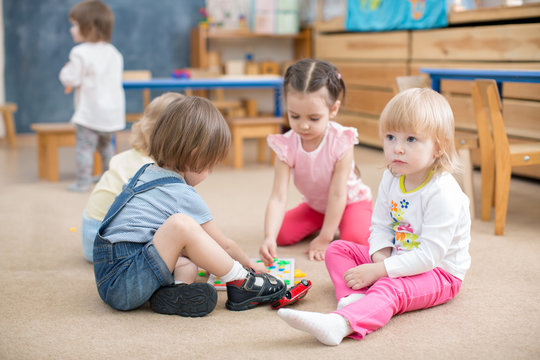 children playing games in kindergarten playroom 