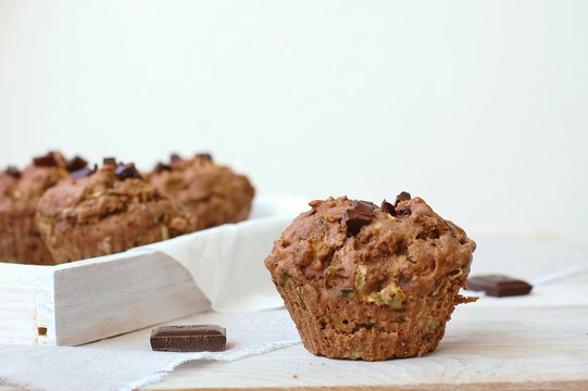 Chocolate muffins on the white and pink background