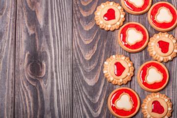 cookies with jelly on a dark wooden background