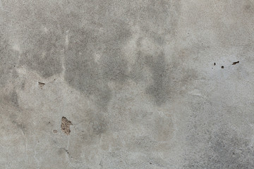 Old grey stucco wall with cracked plaster. Background texture