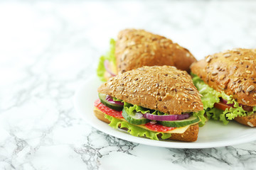 Tasty sandwiches with salami on a white table