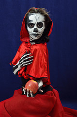 Girl makeup skeleton offering apple