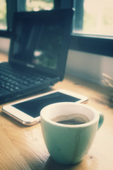 Notebook computer with coffee and smart phone