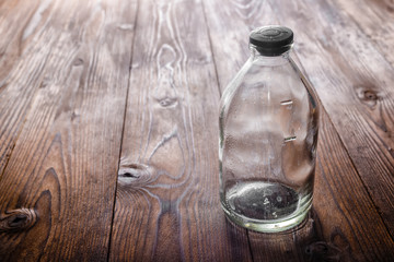 Obraz na płótnie Canvas top view of dirty empty vintage glass medicine bottle with stopp