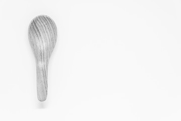 Black and white view of Classic wooden spoon with white background and selective focus