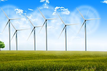 Wind energy turbines spinning on agricultural field on a summer day