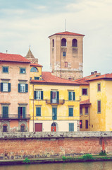 Fototapeta na wymiar Medieval buildings along river Arno in Pisa, Italy.