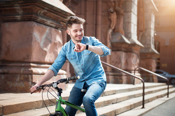 Positive guy sitting on the bicycle