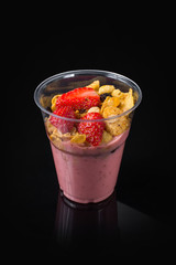 Chia Pudding with Strawberry in plastic cup on Black2