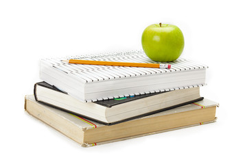 school books with green apple