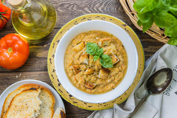 Gazpacho and ingredients on a table, vegetable soup