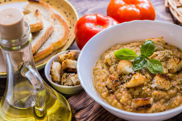 Gazpacho and ingredients on a table, vegetable soup