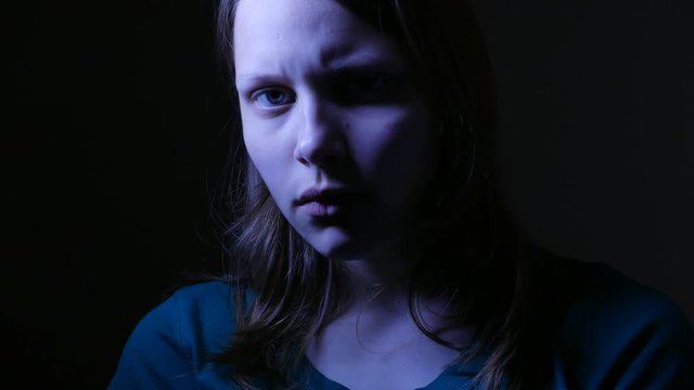 Close-up portrait of depressed teenager being sad. 4K UHD
