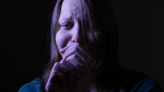 Close up of a scared and crying teen girl. 4K UHD.