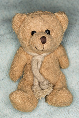 small teddy bear with ocher colors gleam in his eyes