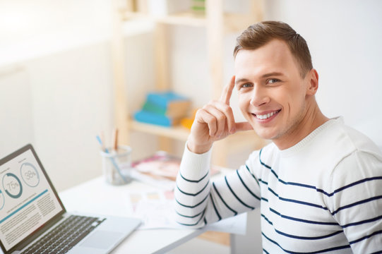Cheerful guy sitting at the table 