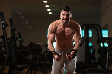 Fototapeta na wymiar Chest Workout Cable Crossover In Gym
