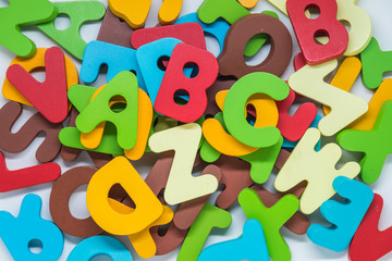 Colorful wooden alphabet on white background