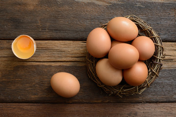 Brown egg in nest on a wooden table