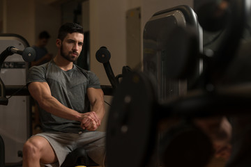 Athletic Man Showing His Muscles In Gym