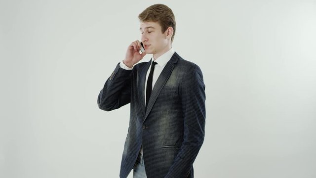 young man is talking on a phone