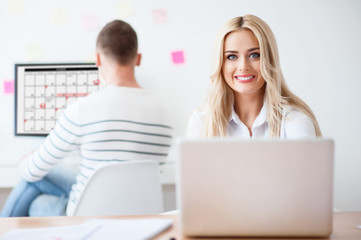 Positive woman sitting at the table 