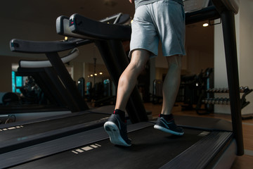 Fototapeta na wymiar Exercising On A Treadmill Close-Up