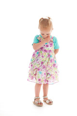 Shy toddler girl in summer dress