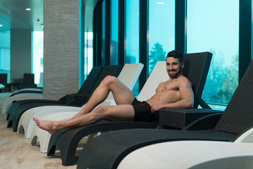 Young Athlete Resting On Sun Lounger
