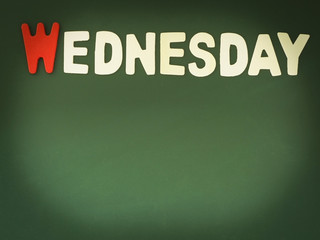 Wooden Wednesday on Green Board. Wood Wednesday word on blackboard with copy space.