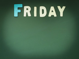 Wooden Friday on Green Board. Wood Friday word on blackboard with copy space.